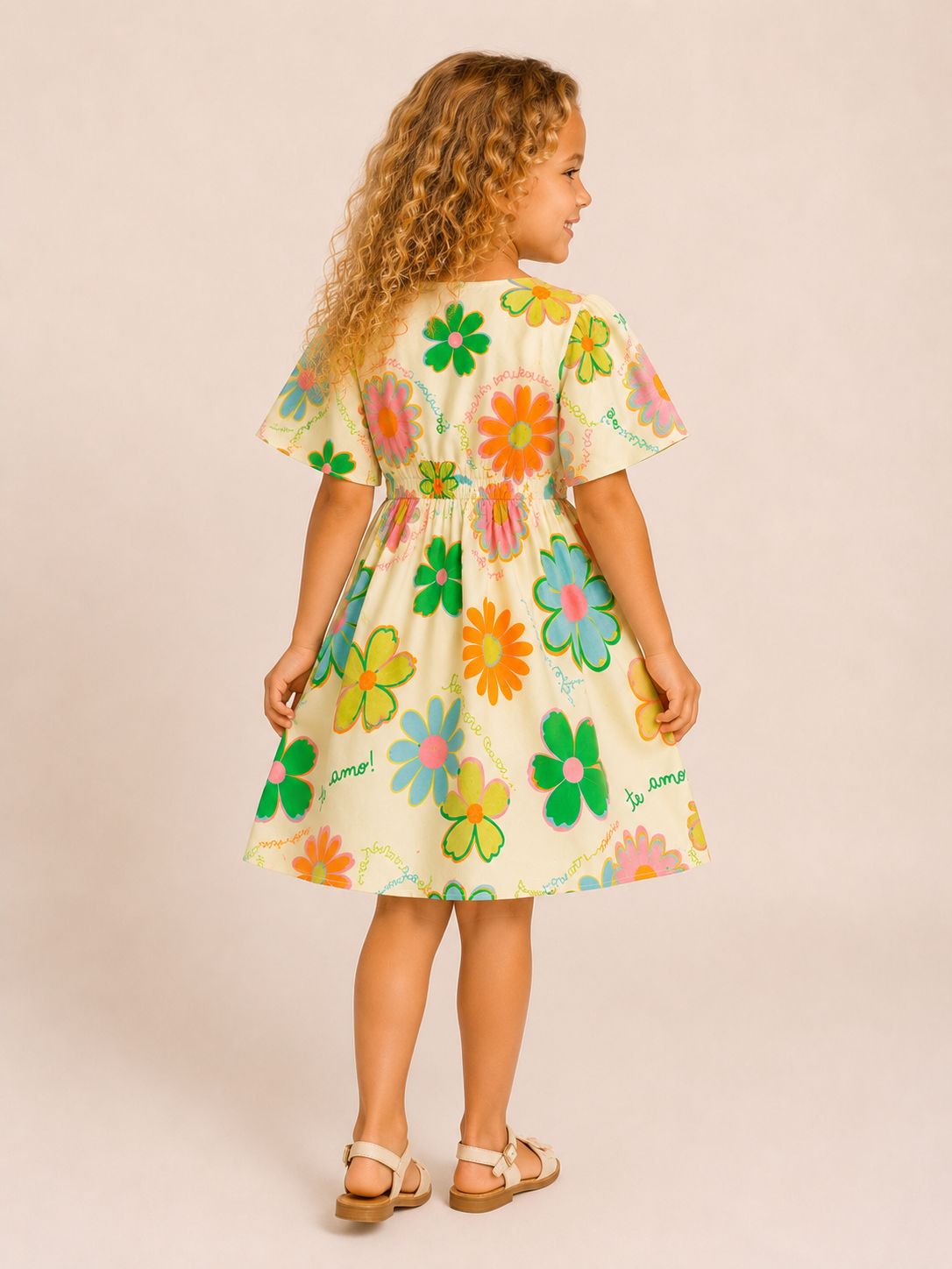 Vestido infantil floral colorido em fundo creme com mangas curtas